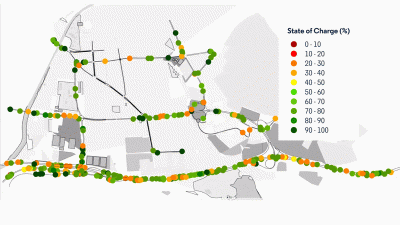 Um mapa de uma cidade com muitos pontos verdes e laranjas nele e uma linha de prédios no outro lado do mapa que mostra a cidade, (um diagrama de arame: 0,439)